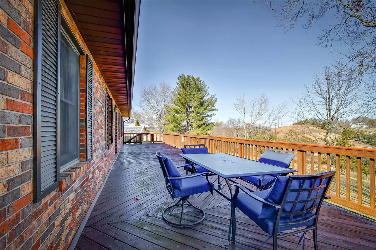 Back deck with patio dining and countryside views at Hillside Hideaway, about 5 minutes from Waterstone Wedding & Event Venue